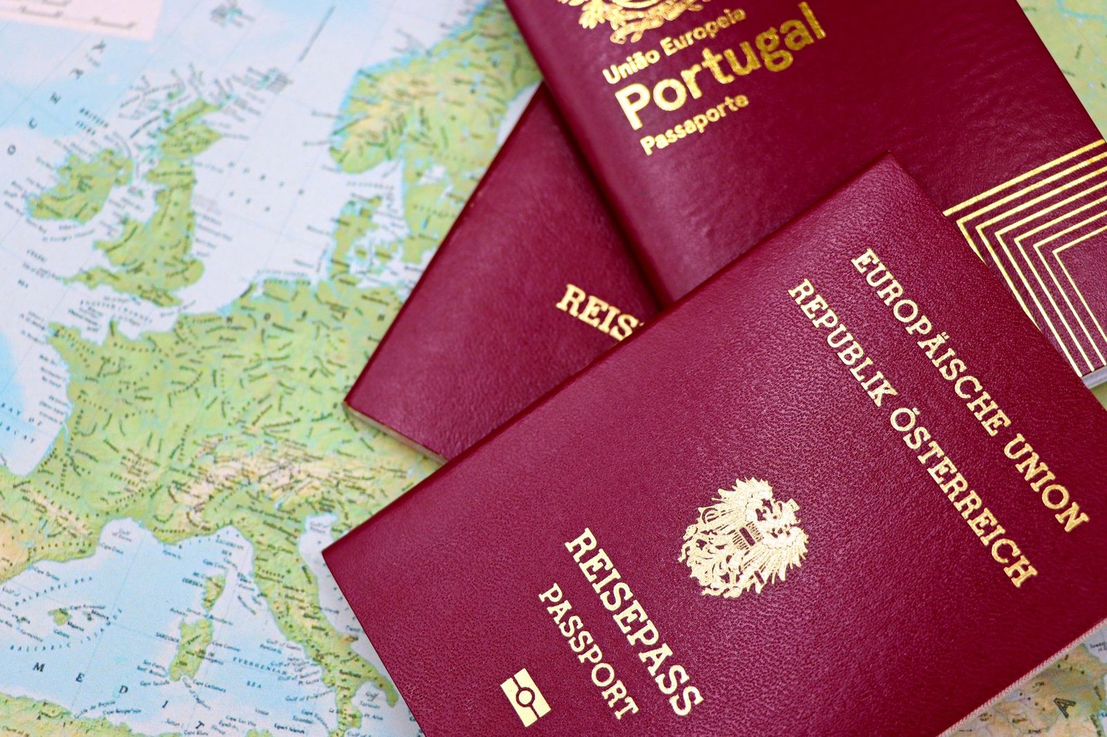 Two European Union passports lying on a world map