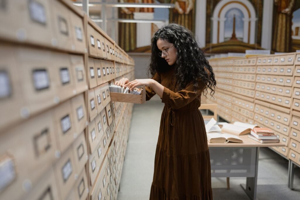 Woman browsing archive drawer – searching for a birth certificate