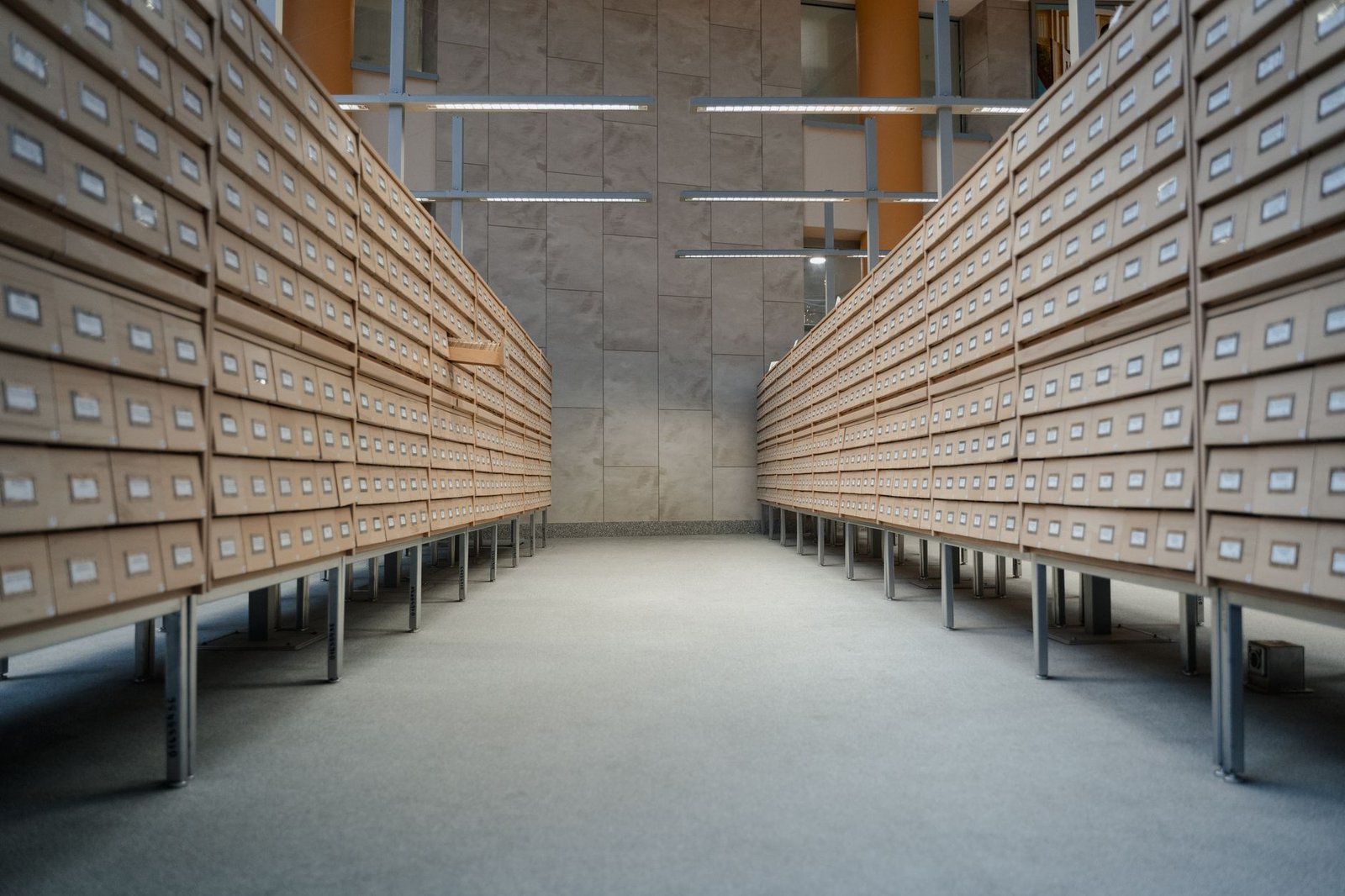 Modern library archive with rows of wooden document drawers