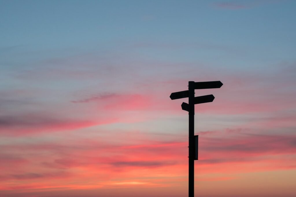 Direction signs with arrows — choice of options at golden hour