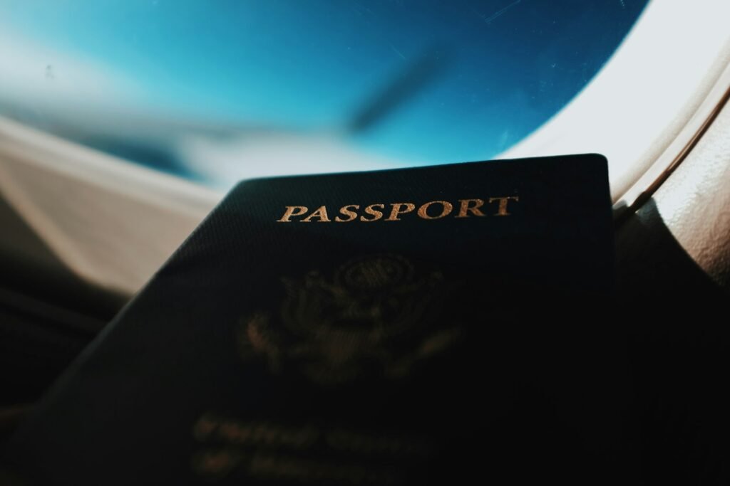 Passport silhouette against airplane window – travel abroad