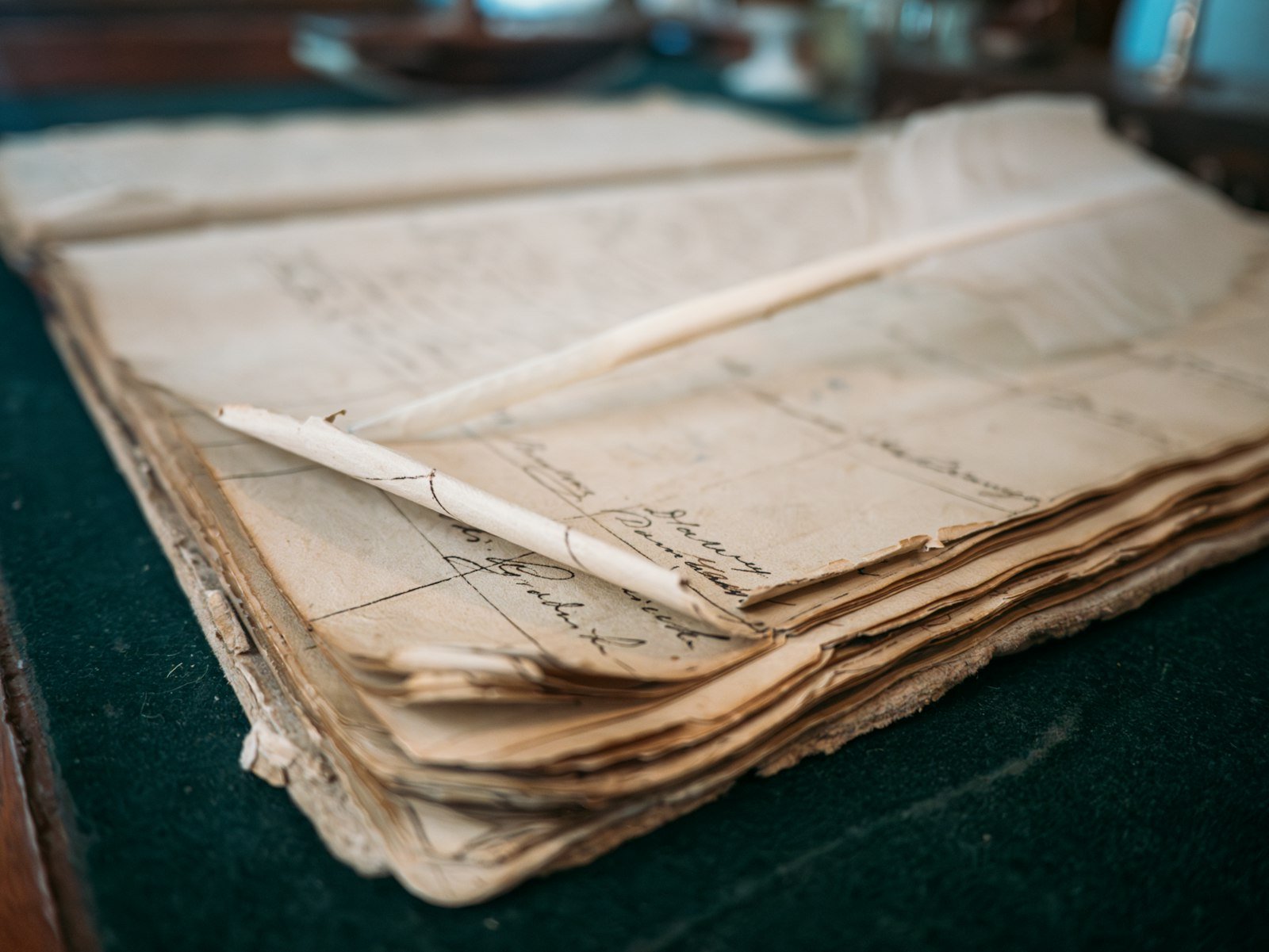 A close-up of an old open ledger with handwritten notes