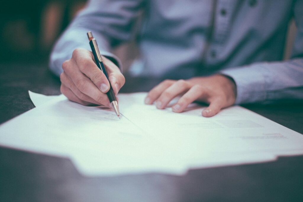 Hand signing "Sign here" document – name or surname change