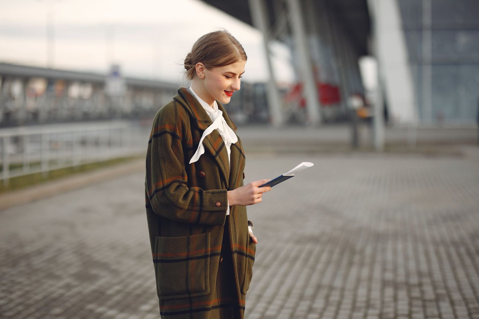 Young woman with passport at airport – Lithuanian citizenship after age 18